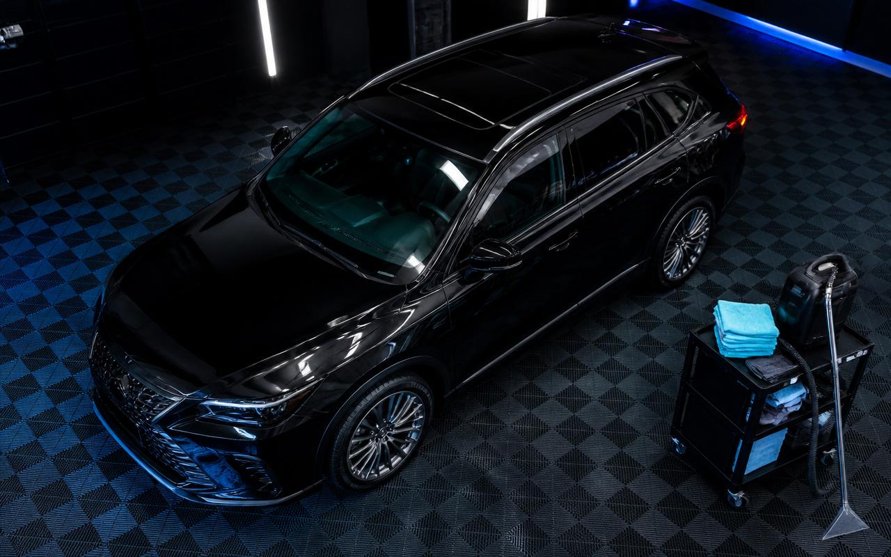 Fully detailed black luxury SUV finished top to bottom inside a premium detailing bay in Lewisville, NC